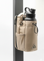 Beige pouch with water bottle holder attached to a pole on a white background